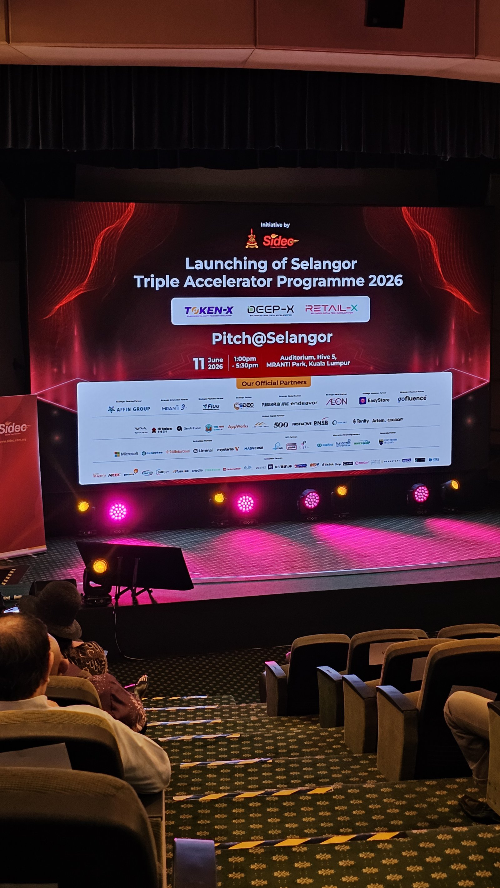 Stage screen at the launch of SIDEC's Selangor Triple Accelerator Programme 2026 featuring Token-X, Deep-X and Retail-X at MRANTI Park, Kuala Lumpur
